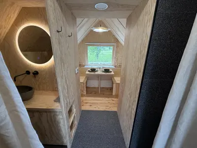 a small bathroom with a sink and a mirror at Telaj Residence - Cosy Cabins near Bovec, Soča Valley in Bovec