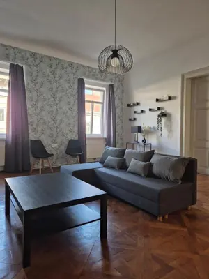 a living room with a couch and a coffee table at Center flat 160m2 in Ljubljana