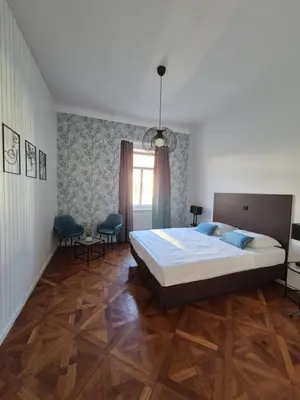 a bedroom with a large bed and a window at Center flat 160m2 in Ljubljana