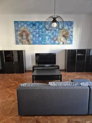 a living room with a couch and a painting on the wall at Center flat 160m2 in Ljubljana