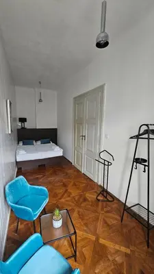 a living room with a couch and a bed in a room at Center flat 160m2 in Ljubljana