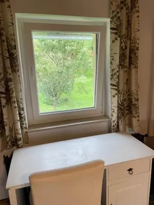 a window in a room with a table and a chair at Eko kmetija Sen na Zgornji Kapli in Zgornja Kapla