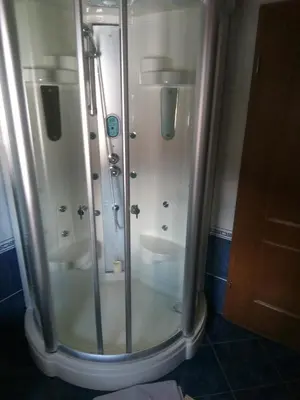a shower stall with two sinks in a bathroom at Tubej apartments in Bohinj
