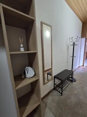 a room with a mirror and a table and a stool at Ludanov apartma in Radlje ob Dravi