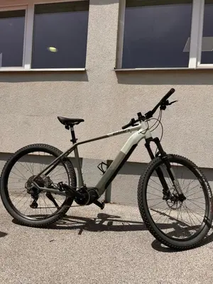 a bike parked in front of a building at Ludanov apartma in Radlje ob Dravi