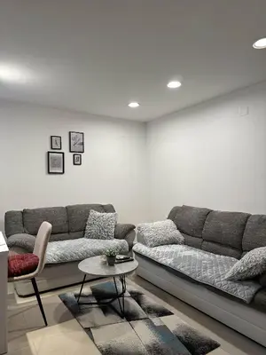 a living room with a couch and a table at Apartments Dani in Postojna