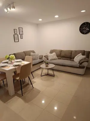 a living room with a couch and a table at Apartments Dani in Postojna