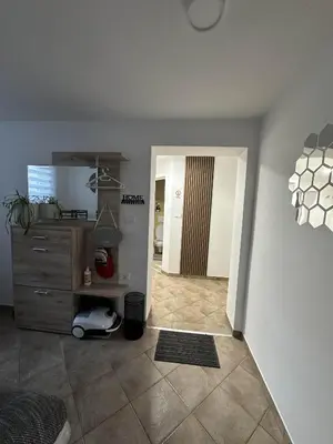 a living room with a room with a dresser at Apartments Dani in Postojna