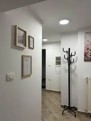 a room with a cross on a wall with pictures at Apartments Dani in Postojna