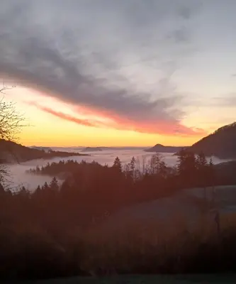 a view of a foggy valley at sunset at Apartma Saint Thomas in Selca