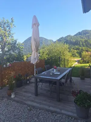 a patio with a table and an umbrella at Apartma Saint Thomas in Selca