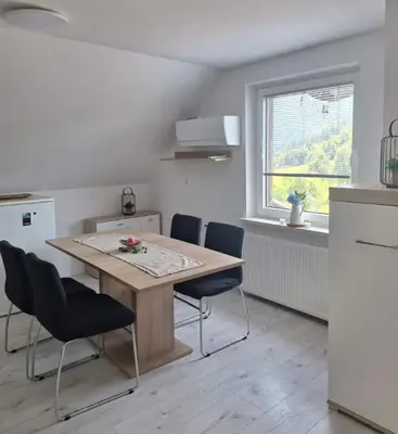a kitchen with a table and chairs and a window at Apartma Saint Thomas in Selca