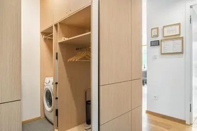 a laundry room with a washer and dryer at West Alpine Apartment SKI in&out in Kranjska Gora