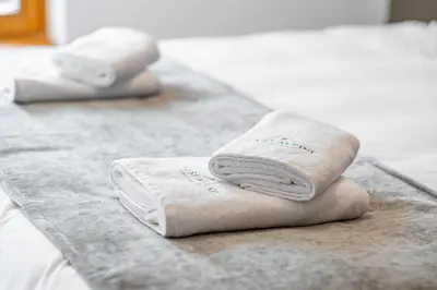 a couple of towels sitting on top of a bed at West Alpine Apartment SKI in&out in Kranjska Gora