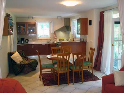 a kitchen with a table and chairs in a room at Apartment Kotnik in Kamnik