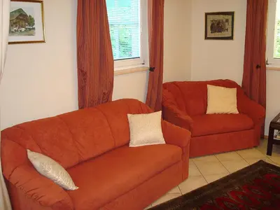 a living room with a couch and a chair at Apartment Kotnik in Kamnik