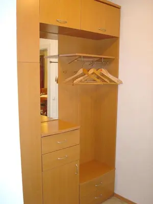 a closet with wooden cabinets and hangers at Apartment Kotnik in Kamnik