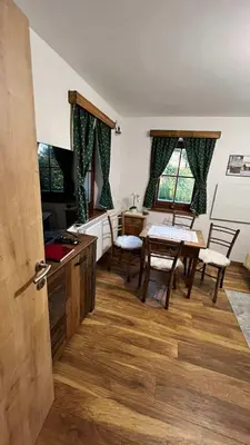 a kitchen with a table and chairs and a dining room at Apartment Olga