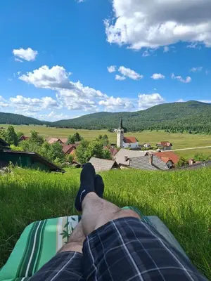 a person laying on a blanket in a field with their feet in the grass at Apartment Olga