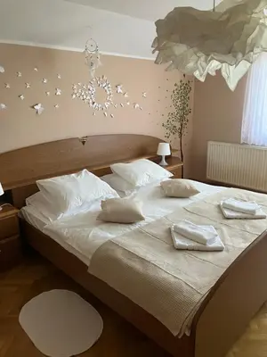 a bedroom with a bed with two white towels on it at Kozjanski odklop in Buče