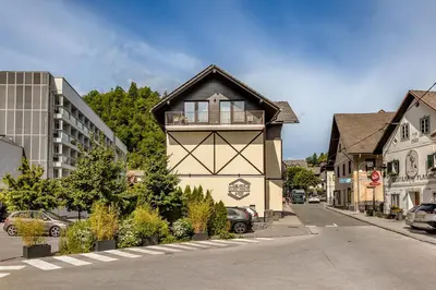 a small building on the side of a street at Guest House The Hive in Bled