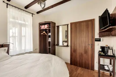a bedroom with a bed and a wooden door at Guest House The Hive in Bled
