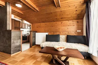a living room with a couch and a table at Guest House The Hive in Bled