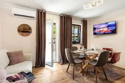 a living room with a dining room table and a couch at Garden House 202 by Sigismundi in Brežice