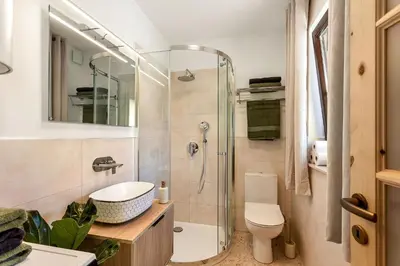 a bathroom with a shower and a sink and a toilet at Garden House 202 by Sigismundi in Brežice