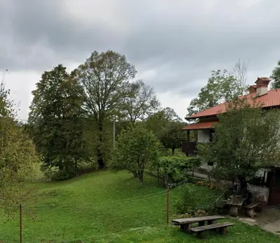 a house with a picnic table in a yard at Apartma Dajana in Lokve