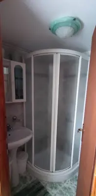 a bathroom with a shower and a sink at Apartma Dajana in Lokve