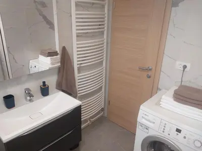 a bathroom with a washing machine and a washer at APARTMA Črnomelj in Črnomelj