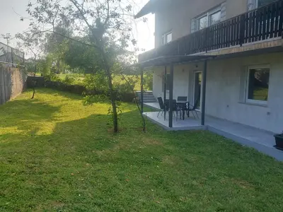 a porch of a house with a table and chairs at APARTMA Črnomelj in Črnomelj