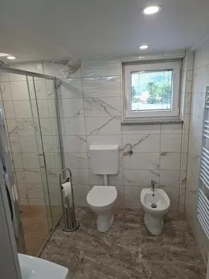 a bathroom with a toilet and a sink at Sun House Luka in Radmirje