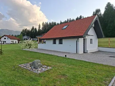 a small white house with a red roof at Sun House Luka in Radmirje