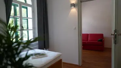 a room with a red couch and a red chair at Snežnik castle estate in Stari Trg pri Ložu