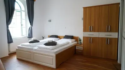a bedroom with a bed with two teddy bears on it at Snežnik castle estate in Stari Trg pri Ložu