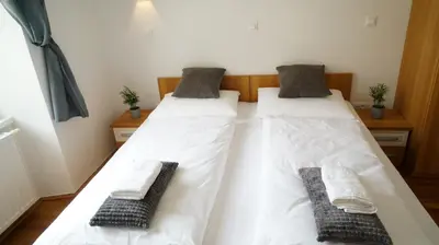 two beds in a room with towels on them at Snežnik castle estate in Stari Trg pri Ložu