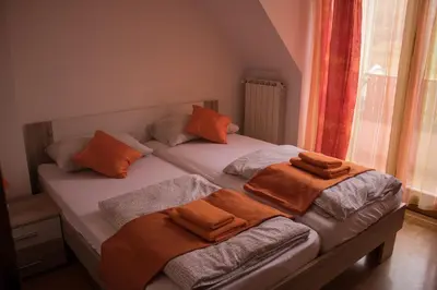 a bedroom with two beds with towels on them at Apartments Kravanja in Bovec