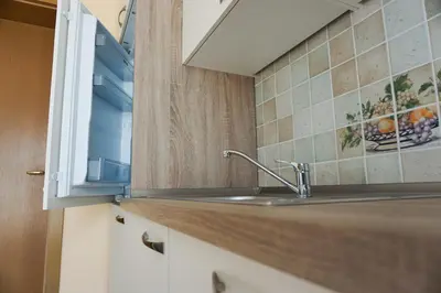 a kitchen counter with a sink and a window at Apartments Kravanja in Bovec