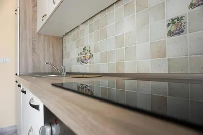 a kitchen with a sink and a counter top at Apartments Kravanja in Bovec