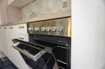 an oven with its door open in a kitchen at Apartments Kravanja in Bovec