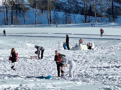 a group of people playing in the snow at Luna's House in Zgornje Jezersko