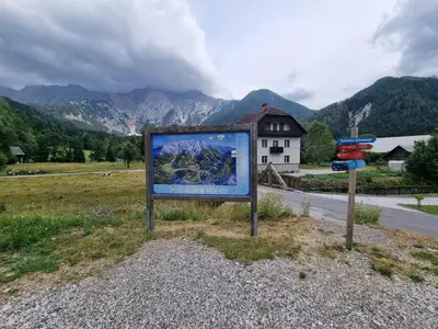 a sign on the side of a road with a mountain at Luna's House in Zgornje Jezersko