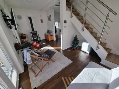 an aerial view of a living room with a staircase at Luna's House in Zgornje Jezersko