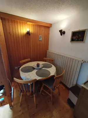 a table in a room with a table and chairs at Traditional Bled Stay in Bled