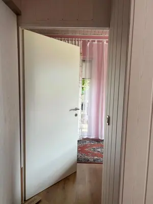 a door leading to a room with a pink curtain at Apartment Tunnel in Hrušica