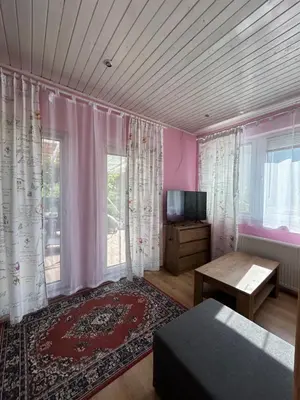 a room with a bed and a tv and a window at Apartment Tunnel in Hrušica