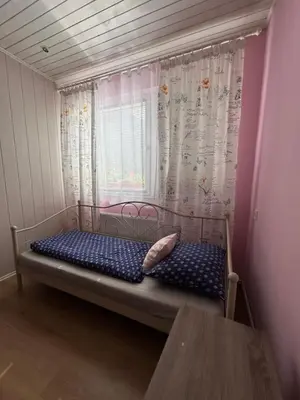 a small bed in a room with a window at Apartment Tunnel in Hrušica