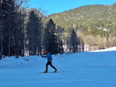 a man is cross country skiing in the snow at Luna's Mountain House - Jezersko in Zgornje Jezersko